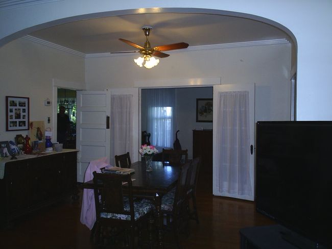 Dining room with wood-type flooring, ceiling fan, and crown molding | Image 12