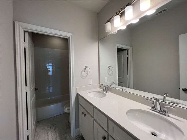 Full bath with marble finish floors, double vanity, and toilet | Image 16