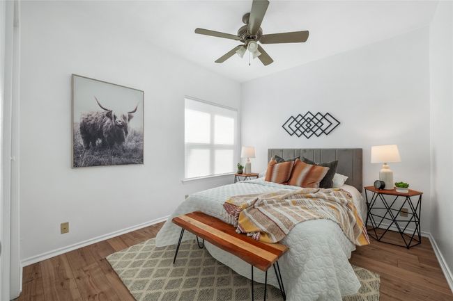 Bedroom featuring wood finished floors and ceiling fan | Image 16