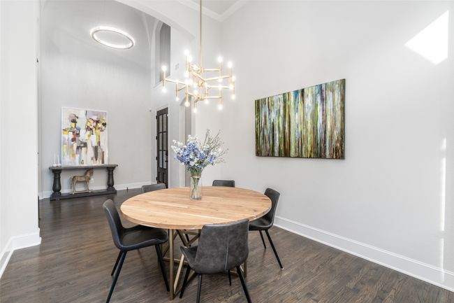Formal dining boasts upgraded light fixture, vaulted ceilings and crown molding. | Image 6