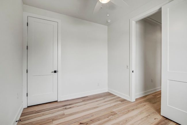 Unfurnished bedroom with light wood-style floors, baseboards, and ceiling fan | Image 18