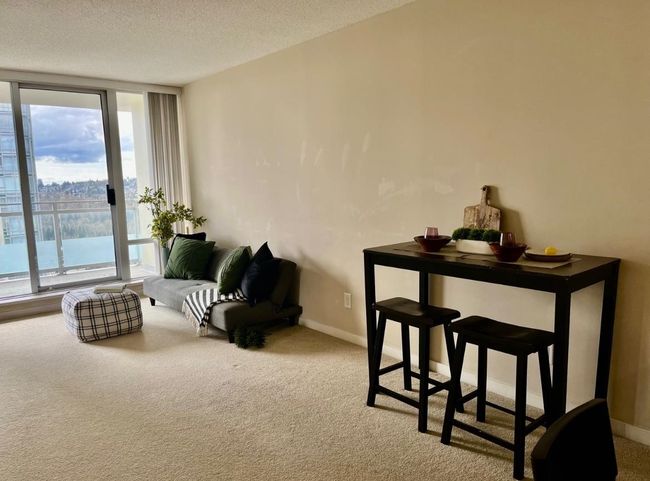 Sitting room featuring floor to ceiling windows, carpet, a textured ceiling, and baseboards | Image 12