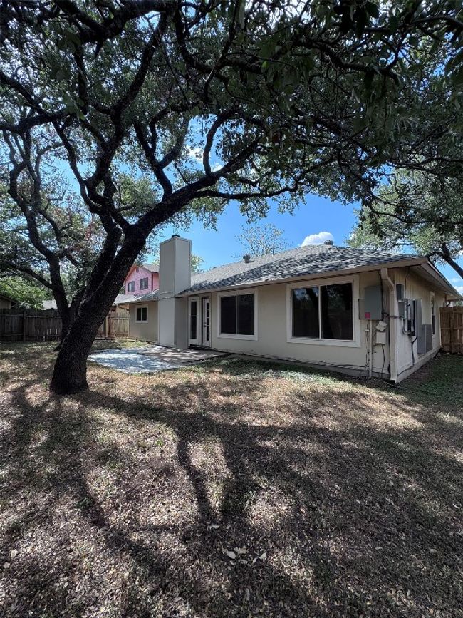 Back of house featuring a patio, roof with shingles, and a chimney | Image 29