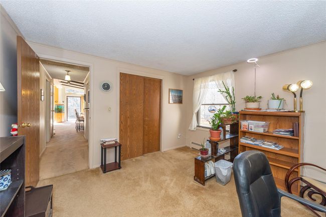 Office area featuring light carpet and a textured ceiling | Image 17