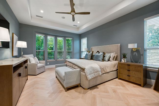 Bedroom with multiple windows, a tray ceiling, baseboards, recessed lighting, and ceiling fan | Image 14