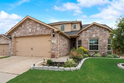 View of front facade with a garage and a front yard | Image 2