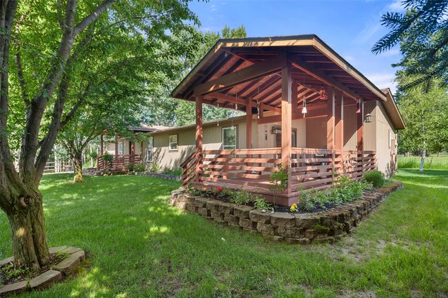 View of property with a deck and a lawn | Image 37