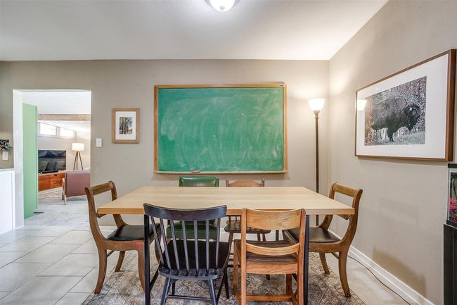 Dining room featuring light tile patterned floors and baseboards | Image 13