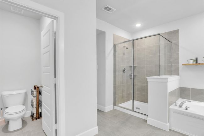 Bathroom featuring tile patterned flooring, independent shower and bath, and toilet | Image 18