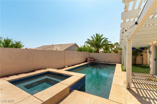 View of pool featuring an in-ground hot tub, a fenced backyard, a patio area, and a pergola | Image 11