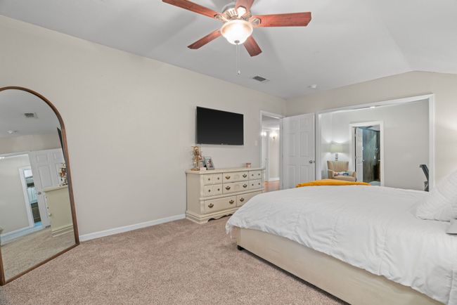 Bedroom featuring light carpet and a ceiling fan | Image 26