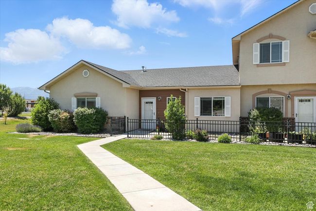 View of front of home featuring stucco siding, a shingled roof, and a mountain view | Image 29