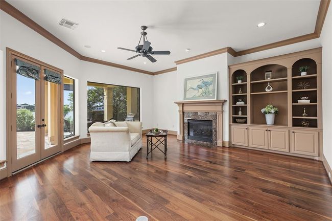 The architectural elegance of this home exudes timeless sophistication. With high ceilings, custom built-ins and walls of windows, the structure itself bathes the interior in natural light, enhancing the expansive feel of the space. | Image 13