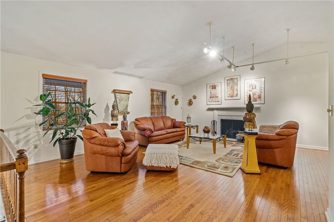 Warm and cozy living room with gleaming wood floors and gas fireplace | Image 4