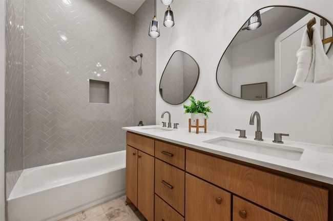 Full bath featuring double vanity and shower / bathtub combination | Image 16