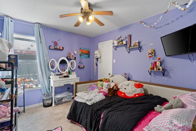 Carpeted bedroom with a ceiling fan | Image 17