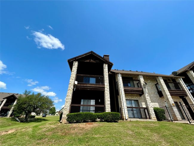 View of building exterior featuring fence | Image 6