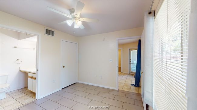 Unfurnished bedroom with light tile patterned floors, ceiling fan, and a closet | Image 18