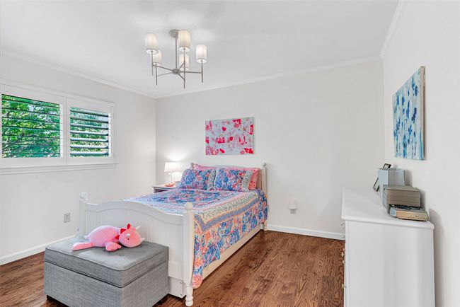 All the bedrooms upstairs offer hardwood floors, updated lighting fixtures, plantation shutters and fresh paint! This bedroom shares a jack & jill bath. | Image 27