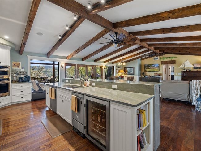 Kitchen features stainless appliances, a wine fridge, cookbook shelves and so much more. | Image 26