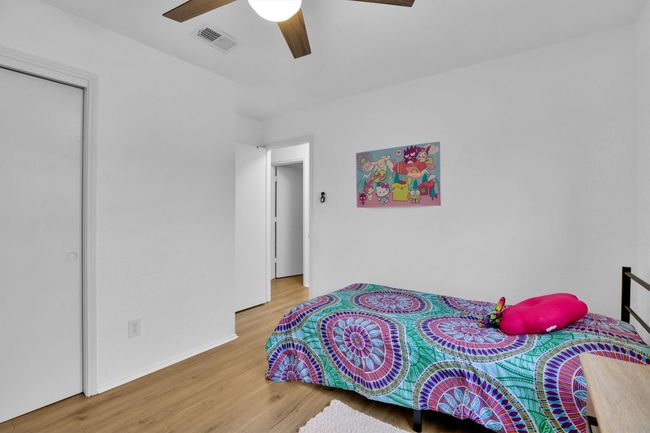 Bedroom with wood finished floors and ceiling fan | Image 26