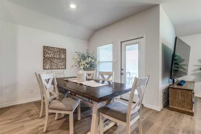 Dining Room View 2 space with light laminated wood plank flooring, and access to the back yard coverd patio. | Image 13