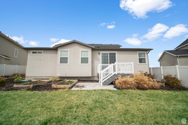 Rear view of house featuring a garden, fence, and a lawn | Image 26