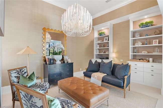 Living area with ornamental molding and a notable chandelier | Image 20