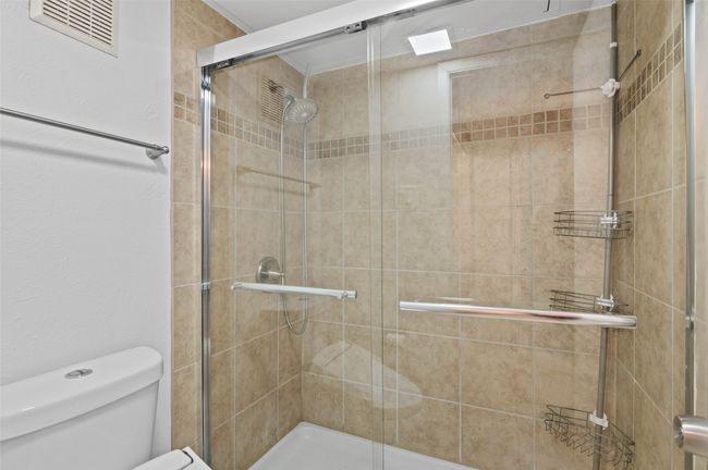 Downstairs full bathroom with custom tile and walk in shower. | Image 16