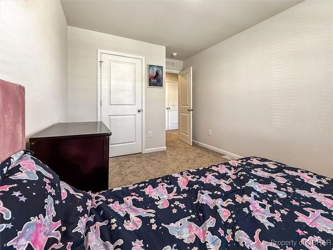 Bedroom with carpet floors, visible vents, and baseboards | Image 24