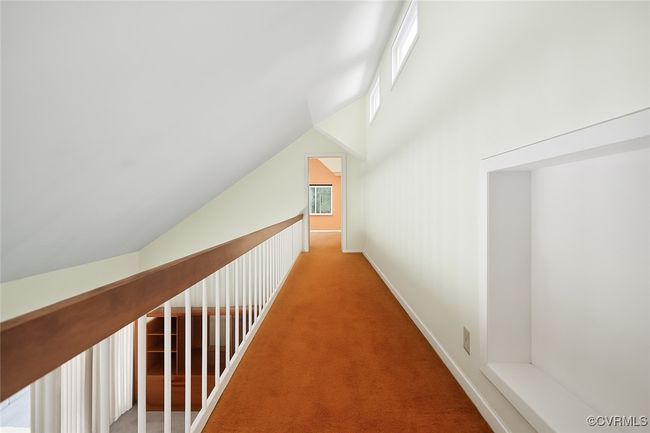Corridor featuring carpet floors and lofted ceiling | Image 24