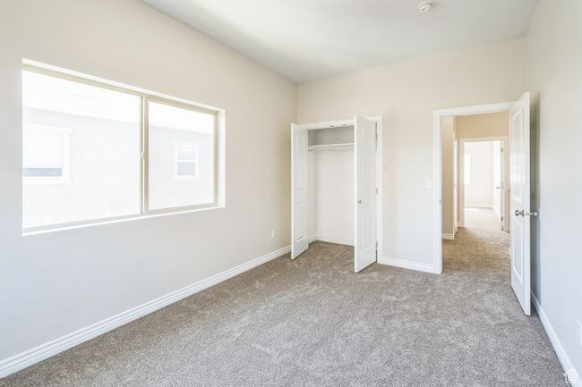Unfurnished bedroom with carpet floors and a closet | Image 38