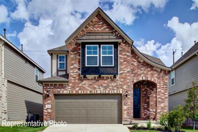 View of front facade with cooling unit and a garage | Image 1