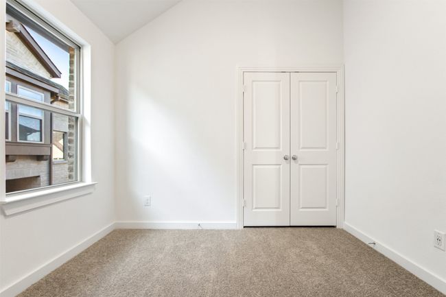 Unfurnished bedroom featuring carpet, vaulted ceiling, and a closet | Image 34