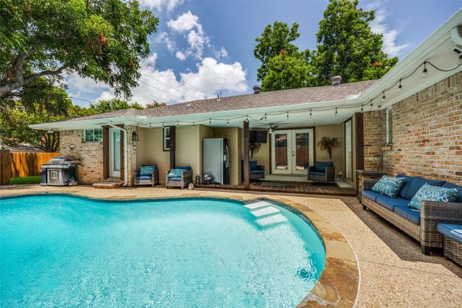Pool and view of the covered back porch. | Image 26