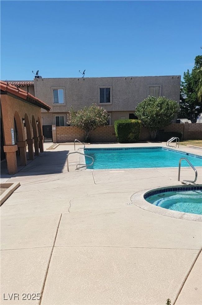 Community pool with fence and a patio | Image 21