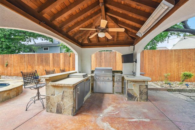 Complete outdoor kitchen/grilling under a wood beamed cabana with seating and room for a table and chairs | Image 36