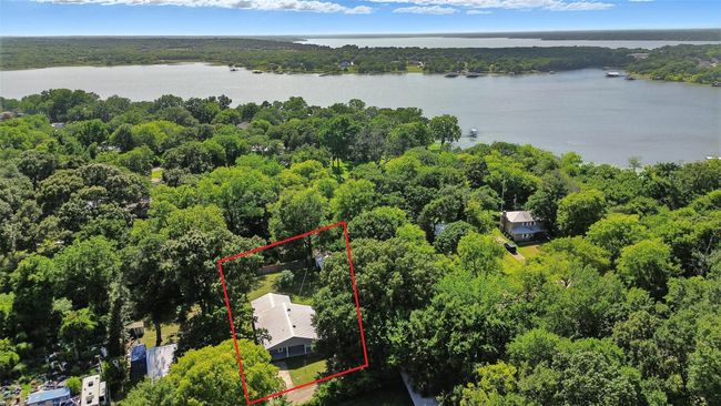 Aerial view of property's location with a large body of water and property boundaries highlighted | Image 9