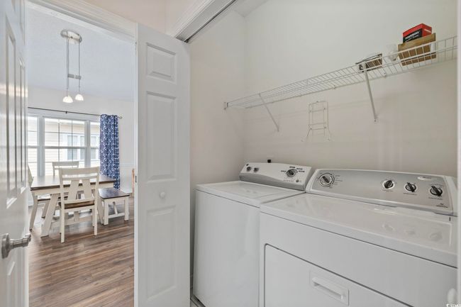 Washroom with washing machine and dryer and wood finished floors | Image 15