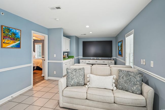 Living area featuring light tile patterned floors, plenty of natural light, and recessed lighting | Image 23