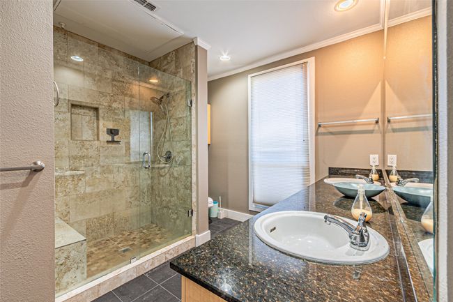 Bathroom with a shower stall, ornamental molding, double vanity, recessed lighting, and tile patterned floors | Image 20