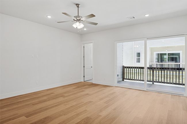Empty room with ceiling fan and light wood-type flooring | Image 11