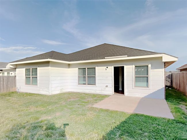 Back of property featuring a fenced backyard, a patio area, and a shingled roof | Image 16