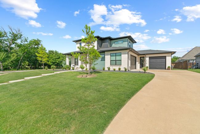 View of front of home featuring concrete driveway and an attached garage | Image 4