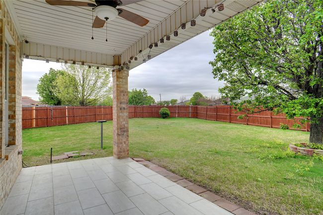 View of yard with a patio, ceiling fan, and a fenced backyard | Image 25
