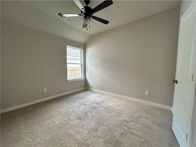 Bedroom with carpet flooring and a ceiling fan | Image 14
