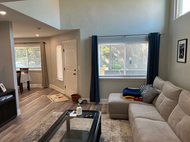 Living area featuring a towering ceiling, wood finished floors, baseboards, and recessed lighting | Image 23