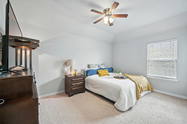 Upstairs Guest Bedroom with light colored carpet, lofted ceiling, and a ceiling fan | Image 23