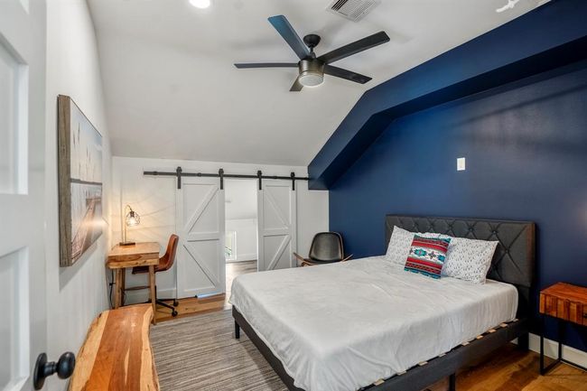 One of two upstairs bedrooms in the other building—offering comfortable accommodations with stylish accents and a functional layout. | Image 34