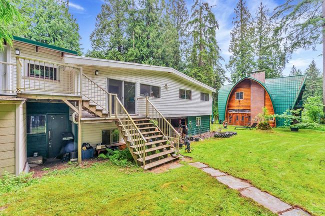 Rear view of house with stairway and a lawn | Image 11